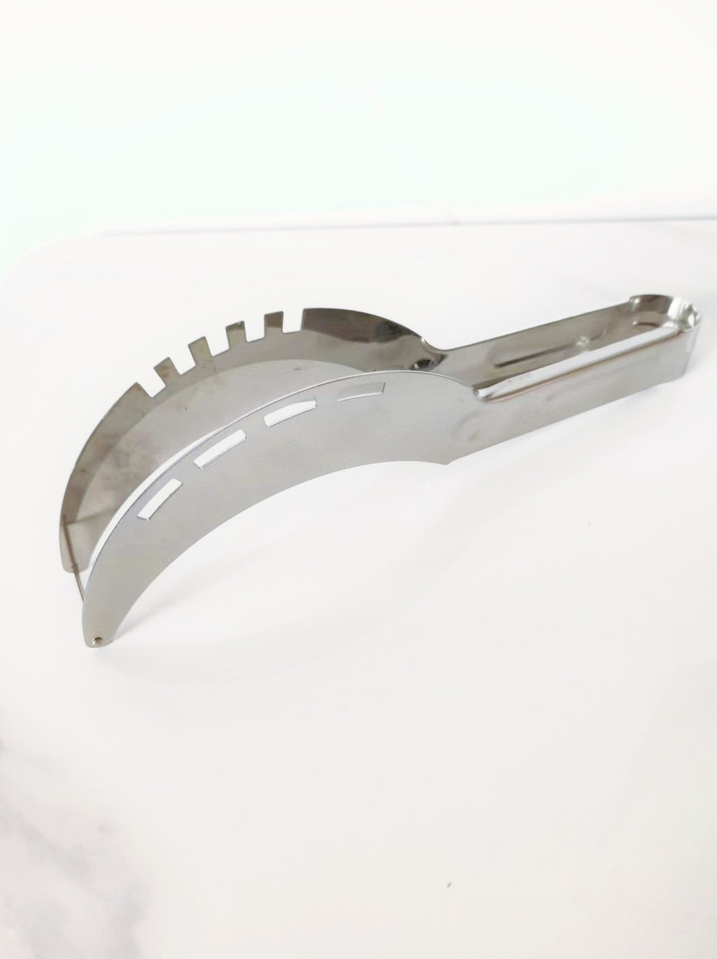A stainless steel watermelon cutting tool